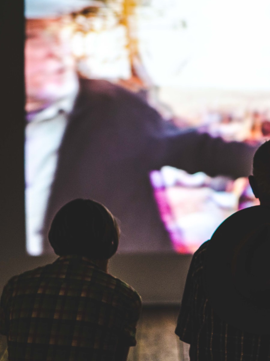 Guests watching a wedding film together at a reception