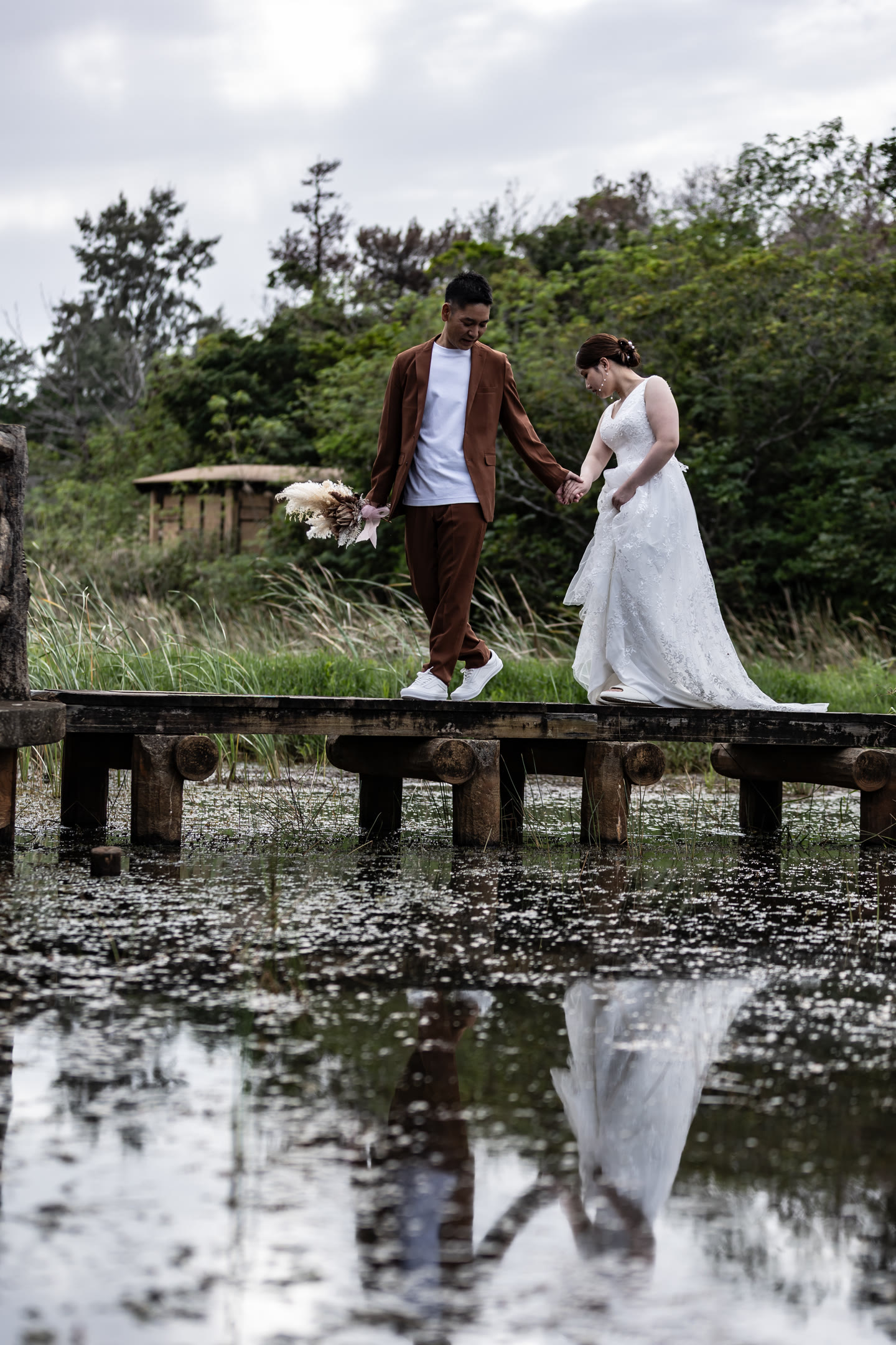 Couple reflected on an Okinawa boardwalk