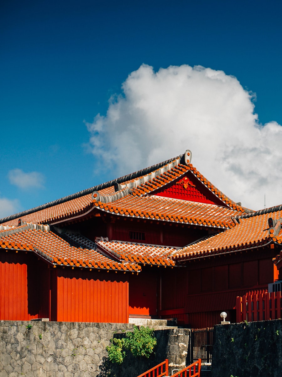 Traditional Ryukyu street in Okinawa with red-tiled roofs and coral stone walls